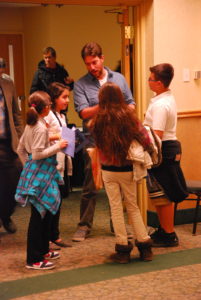 Group of elementary students asking GDPE graduate students questions