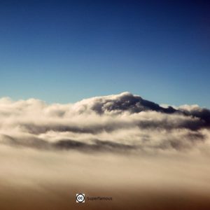 Cloud layer with blue sky above