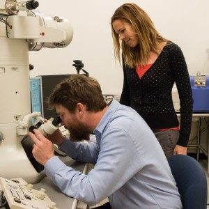 Hall views a microbial organism through the ultrahigh resolution electron microscope