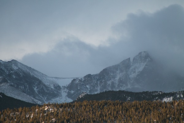 Mountain being enveloved in winter storm clouds