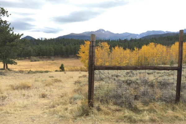 Fence with mountain range in the distance.