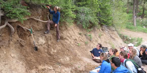 SSI student observing layers of exposed mountain soils