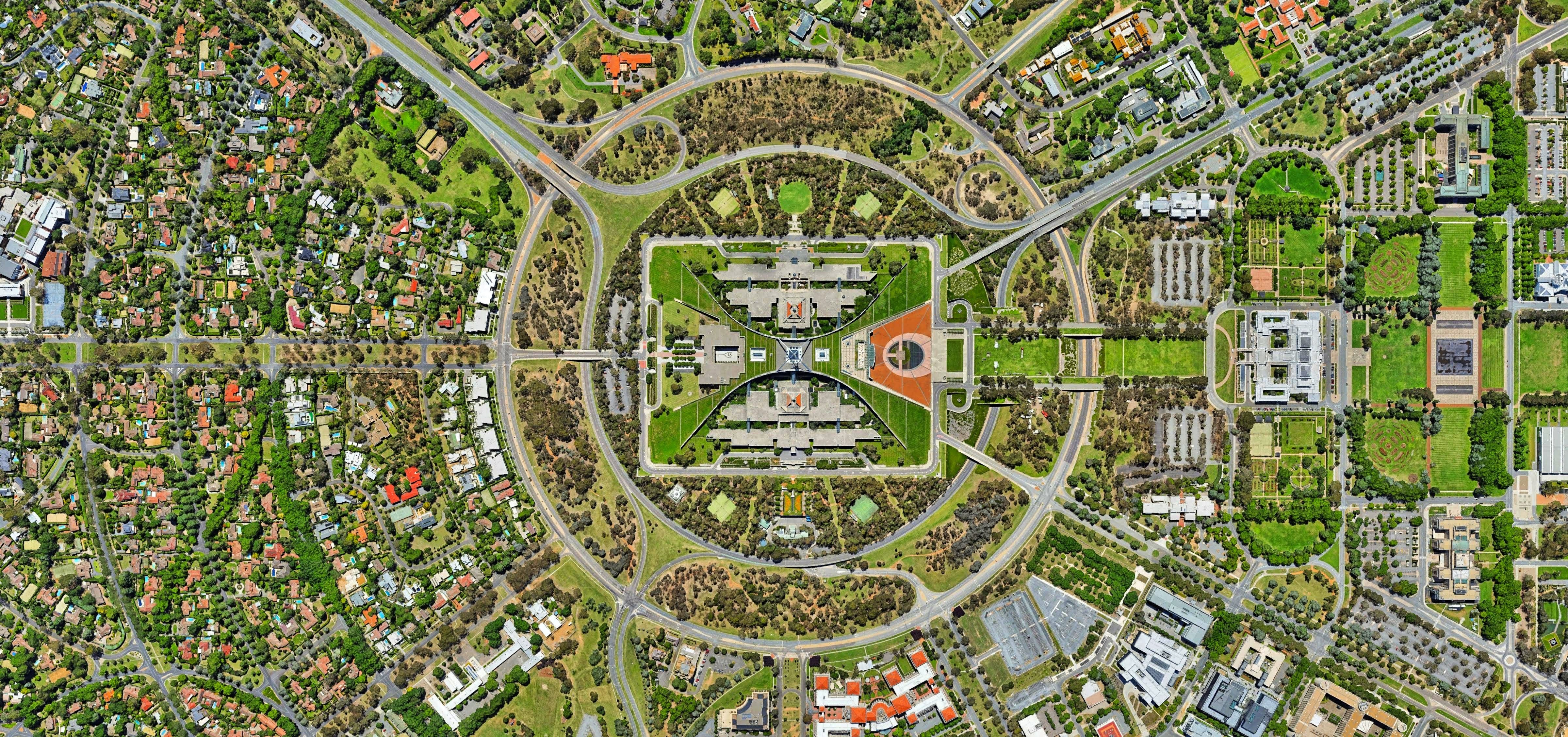 An aerial view of a city with heterogenous land cover (trees, buildings, streets, parks)